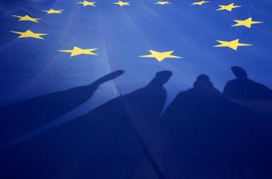 epa04673430 Supporters the Georgia's opposition party 'National Movement' cast shadows on a giant EU flag during a protest rally in Tbilisi, Georgia, 21 March 2015. The Georgian opposition party 'National Movement', of which the former Georgian president Mikheil Saakashvili is the leader, demands resignation of Georgia's government.  EPA/ZURAB KURTSIKIDZE